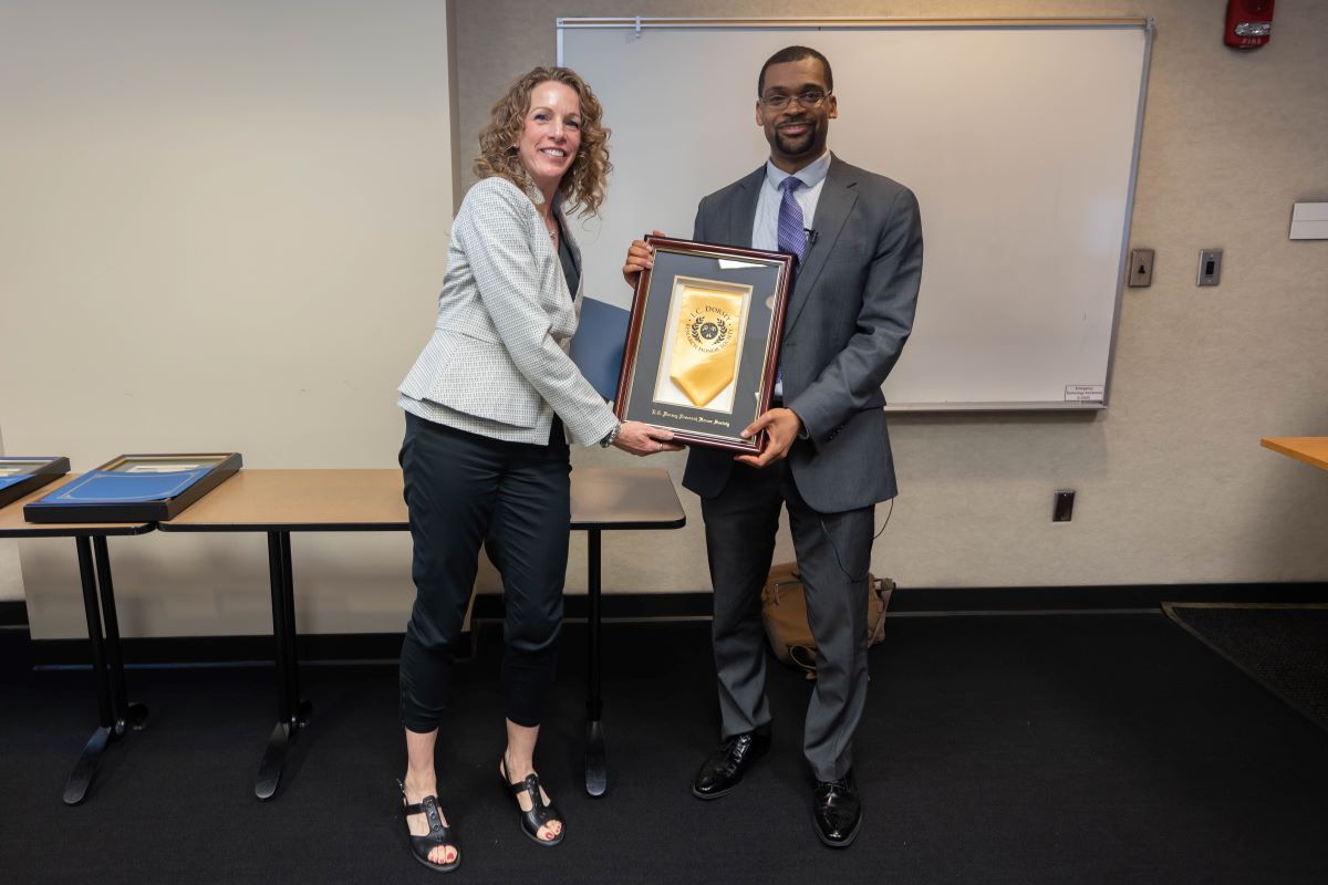 Dr. Reneker standing with a L.C. Dorsey Honor Society Inductee at the 2023 SOPH Research Day